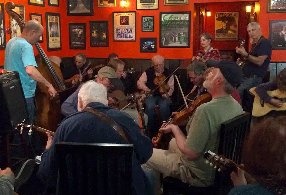 photo of a music jam with bass, fiddles, banjos and guitars