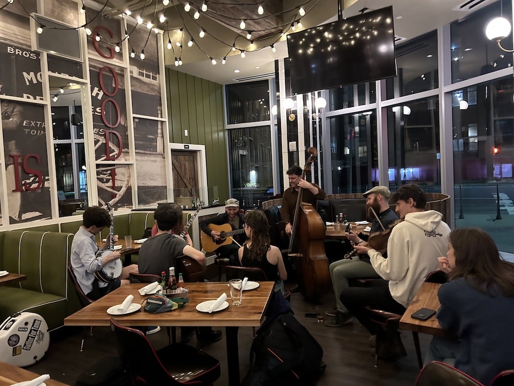 people playing music in a circle at a restaurant