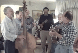 Screen image from a video featuring a band, left to right - Ray Magliozzi, Howie Tarnower, Stan Zdonik, Richie Brown, Ron Faccenda, and Tom Magliozzi playing instruments.