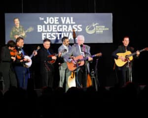 The Del McCoury Band on stage at Joe Val with Fiddle, Banjo, mandolin, Del, and guitar players.